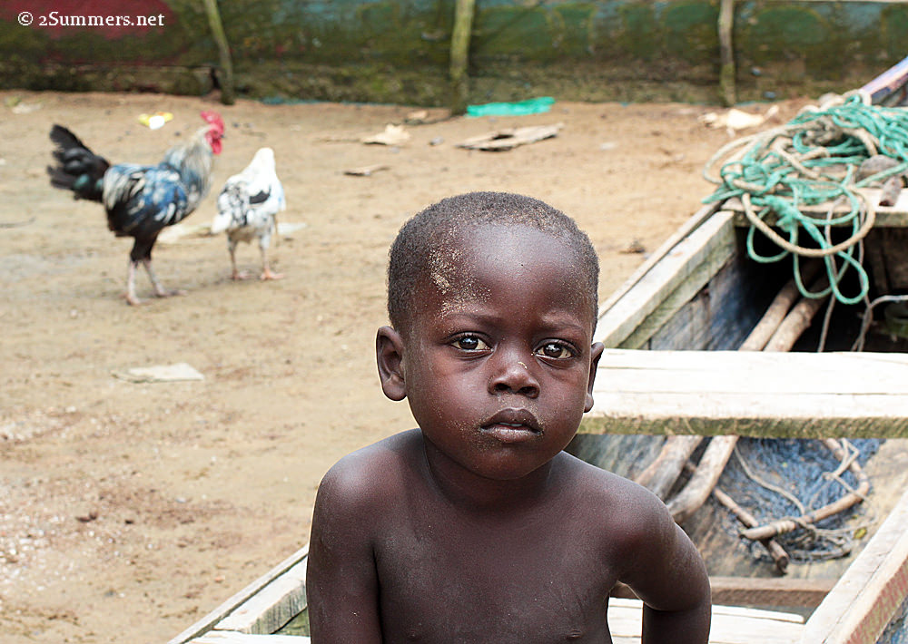 Akwidaa boy and chickens