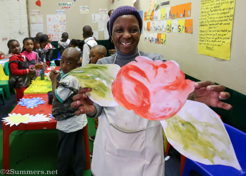 Teacher Pauline with a paper flower