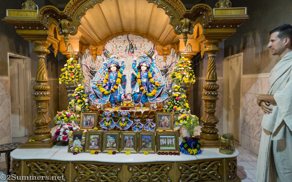 Krishna deities with monk