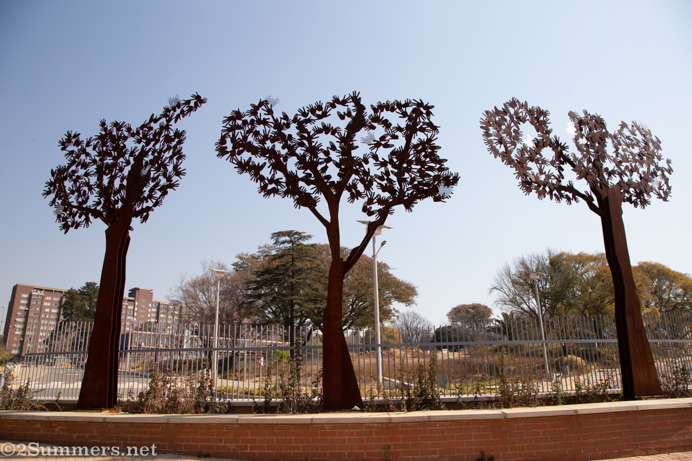 Metal tree sculptures made of hands in Paterson Park