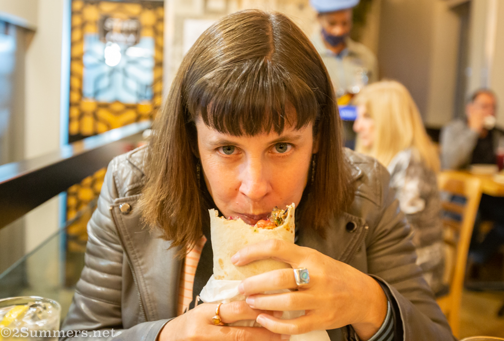 Heather eating a shawarmas at the Schwarma Co.