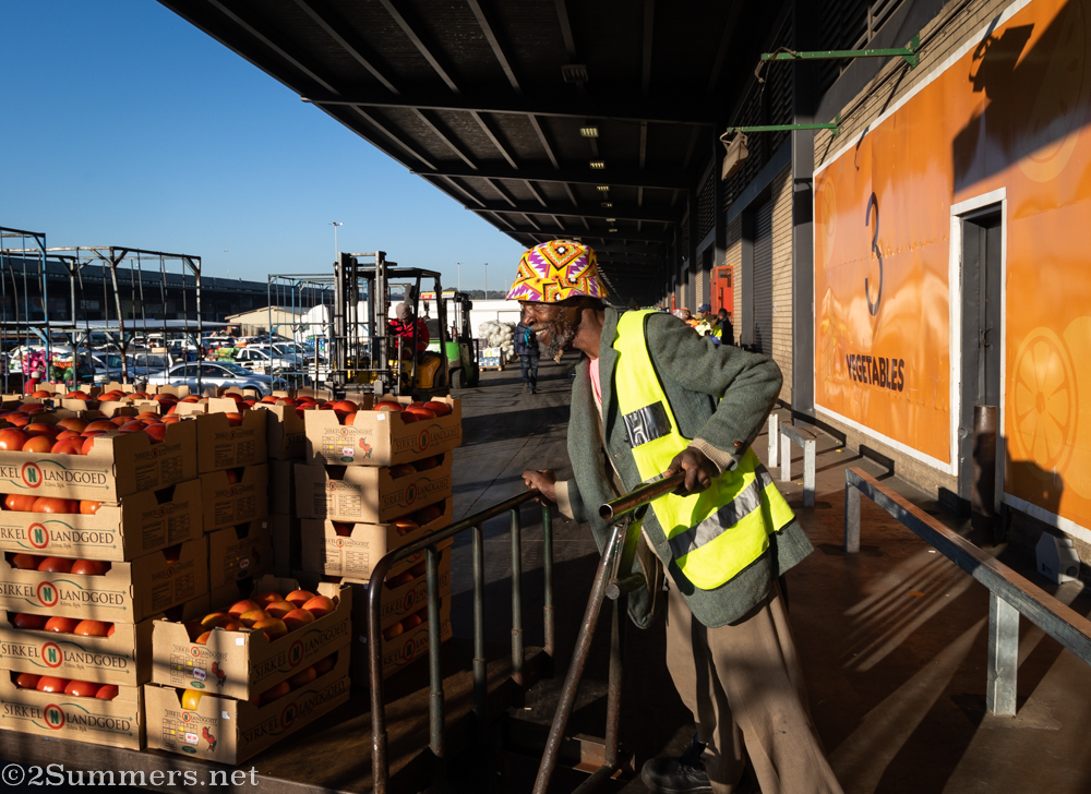 Guy pushing tomato trolley