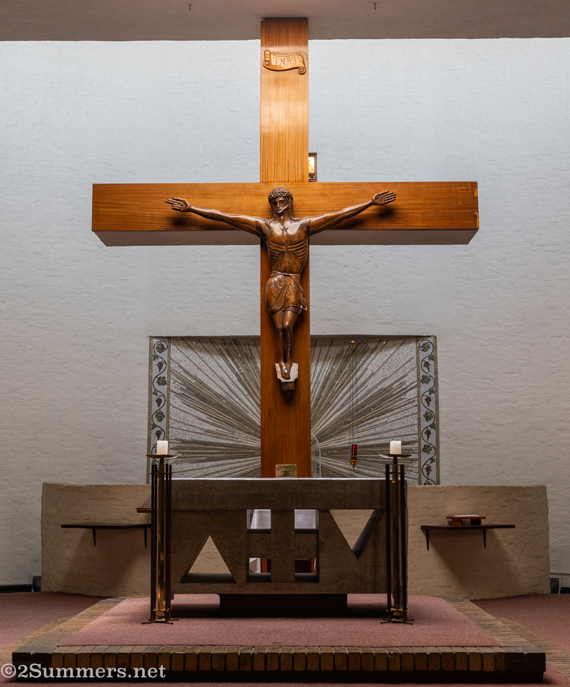 Somehow I didn’t take any wide shots looking straight on into the pulpit. But here is a frame showing the beautiful crucifix carving and mosaic behind the pulpit.