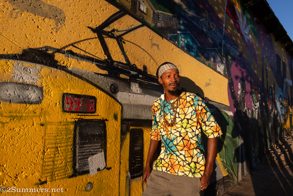 Tsepho from Lebo’s in front of the mural